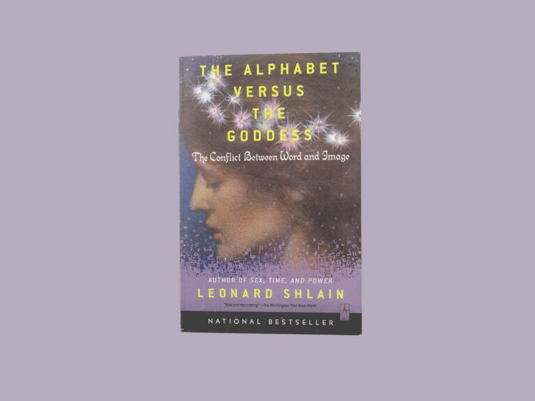 The book, The Alphabet Versus the Goddess, centered on a purple background.