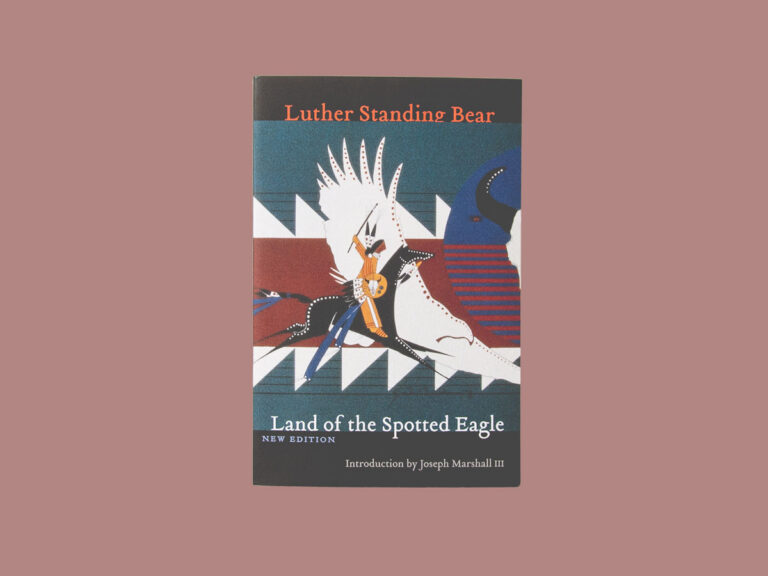 The book, Land of the Spotted Eagle, centered on a red background.