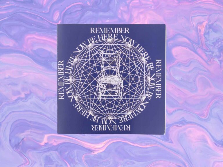 The book Be Here Now with a purple and pink psychedelic background